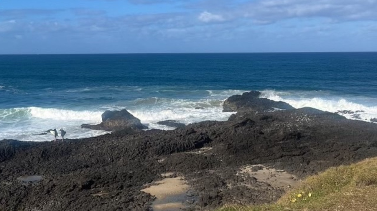 The brothers were brought to the sandy spot in the rocks after they were pulled from the water. Picture: Michael Crisp