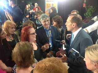 Opposition leader Tony Abbott talks to the punters after the Brisbane forum. He says he will axe 12,000 Commonwealth jobs through natural attrition but has buried Work Choices laws. Picture: Rae Wilson