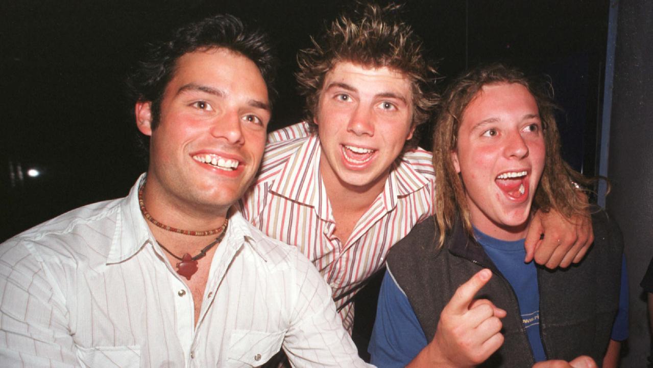 Adrian Davey, Josh Home and Michael Horgan celebrate at the Rolling Rock nightclub in December 2002. Picture: Sharyn Rosewarne
