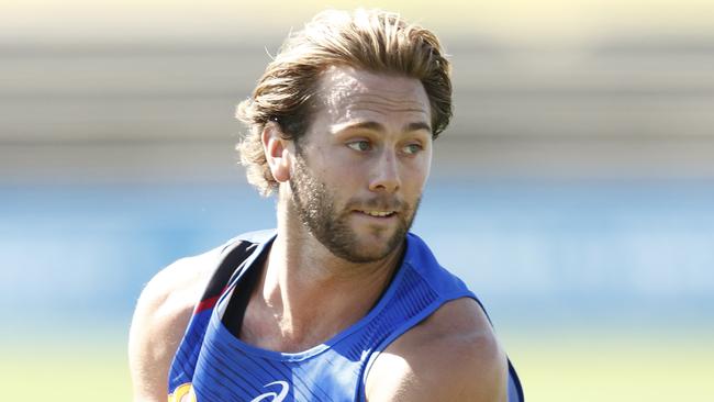 MELBOURNE, AUSTRALIA - JANUARY 20: Caleb Daniel of the Bulldogs runs with the ball during a Western Bulldogs AFL training session at Whitten Oval on January 20, 2021 in Melbourne, Australia. (Photo by Darrian Traynor/Getty Images)