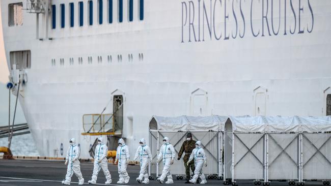 Emergency workers leave the Diamond Princess cruise ship at Yokohama in February after the COVID-19 outbreak. Picture: Getty Images