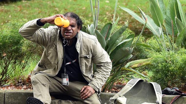 An man washes capsicum spray from his face during the protest. Picture: Julian Smith/AAP