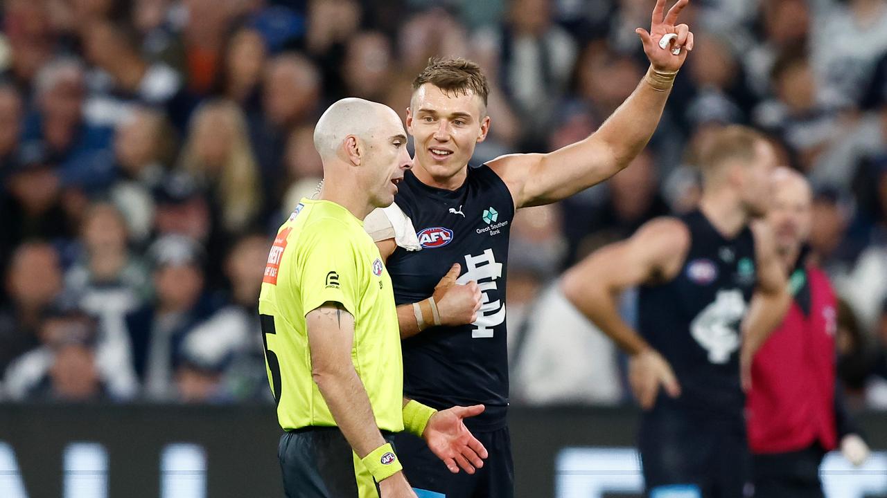 MELBOURNE, AUSTRALIA - APRIL 27: Patrick Cripps of the Blues and AFL Field Umpire, Mathew Nicholls share a discussion during the 2024 AFL Round 07 match between the Geelong Cats and the Carlton Blues at the Melbourne Cricket Ground on April 27, 2024 in Melbourne, Australia. (Photo by Michael Willson/AFL Photos via Getty Images)