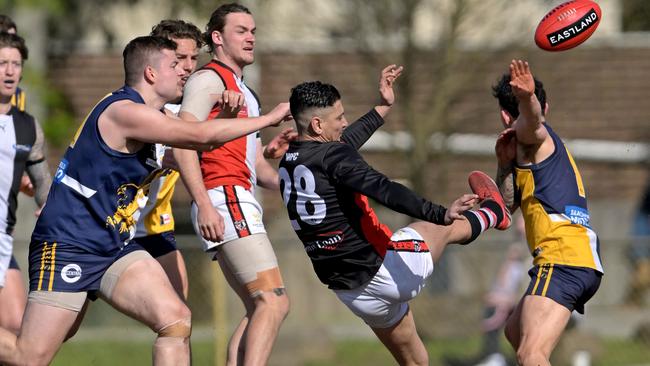 Robin Nahas (No. 28) gets a kick away for North Ringwood. Picture: Andy Brownbill