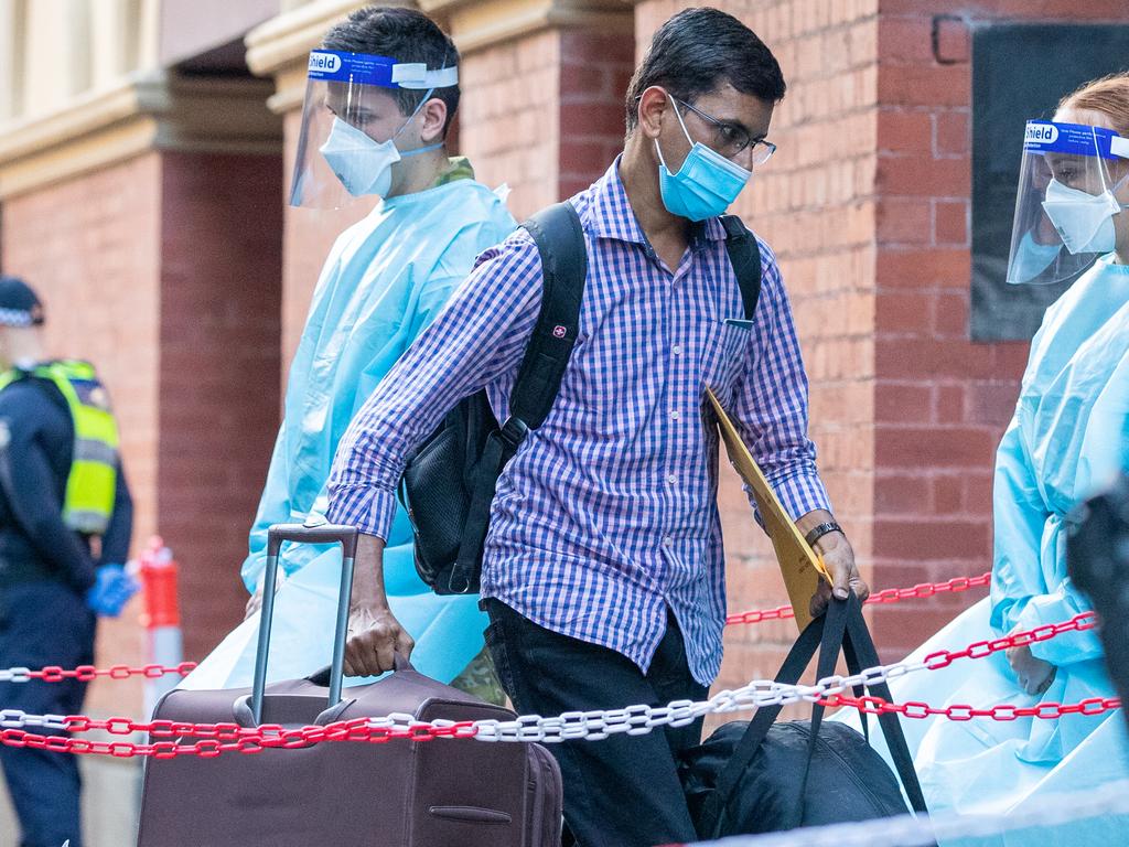 International travellers entering hotel quarantine at the Intercontinental Hotel in Melbourne. NSW and Vic have said the system doesn’t work to contain the virus. Picture: Getty Images