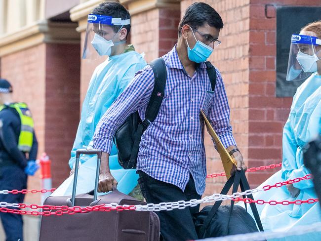 International travellers entering hotel quarantine at the Intercontinental Hotel in Melbourne. NSW and Vic have said the system doesn’t work to contain the virus. Picture: Getty Images