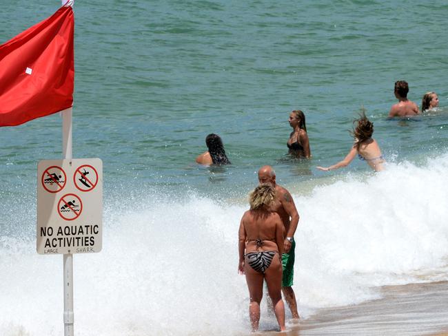 Despite a plethora of shark warning and beach closed signs, swimmers continue to ignore the dangers as frustration sets in over the holiday season. Picture: Peter Lorimer