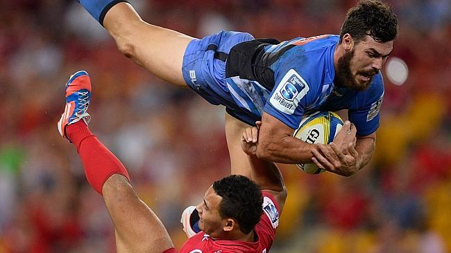 Force fullback Jayden Hayward collides midair with Reds’ Jonah Placid while competing for a high ball at Suncorp Stadium.