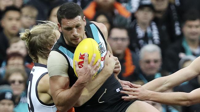 Travis Boak under pressure from GWS defender Nick Haynes. Picture: SARAH REED