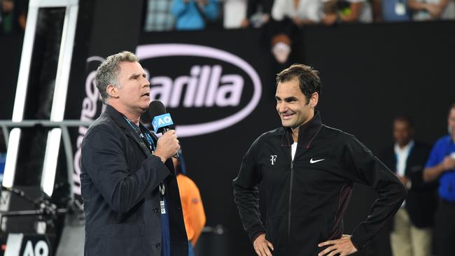 Actor Will Ferrell of the United States (left) conducts a post match interview with Roger Federer of Switzerland after he defeated Aljaz Bedene of Slovenia during round one, on day two of the Australian Open tennis tournament, in Melbourne, Tuesday, January 16, 2018. (AAP Image/Joe Castro) NO ARCHIVING, EDITORIAL USE ONLY