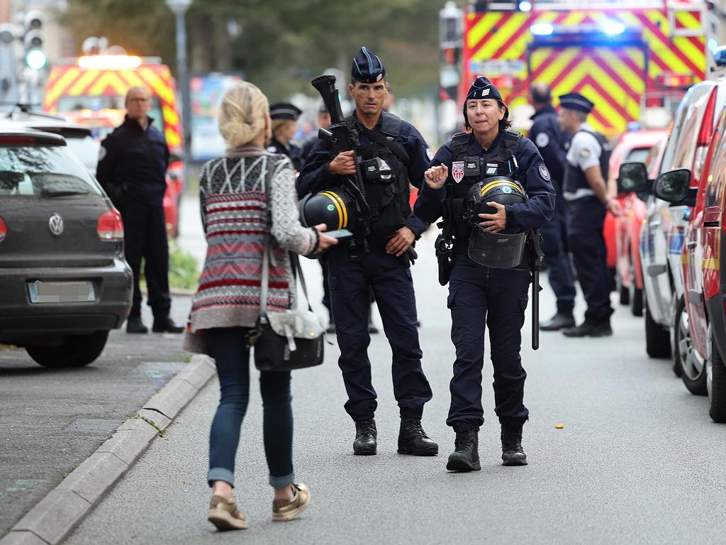 French CRS Police Officers stand guard in front of Gambetta high-school in Arras, Northeastern France where a teacher was killed and two other people severely wounded. Picture: AFP