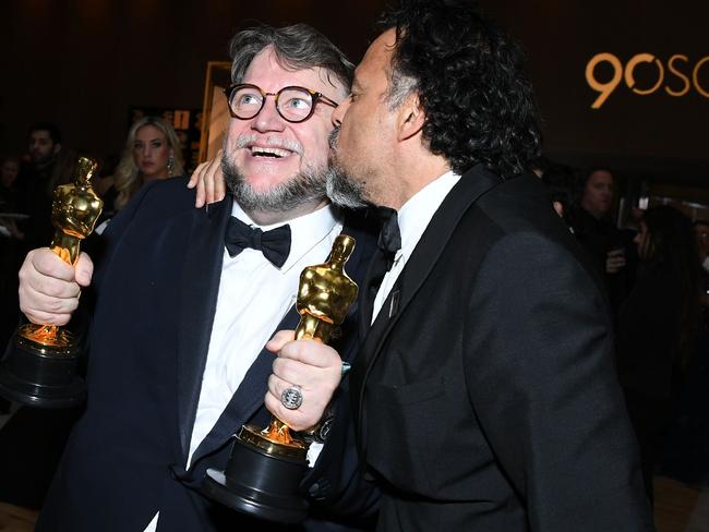 Guillermo del Toro is congratulated by former Oscar winner director Alejandro Gonzalez Inarritu at the Governors Ball. Picture: AFP/Angela Weiss