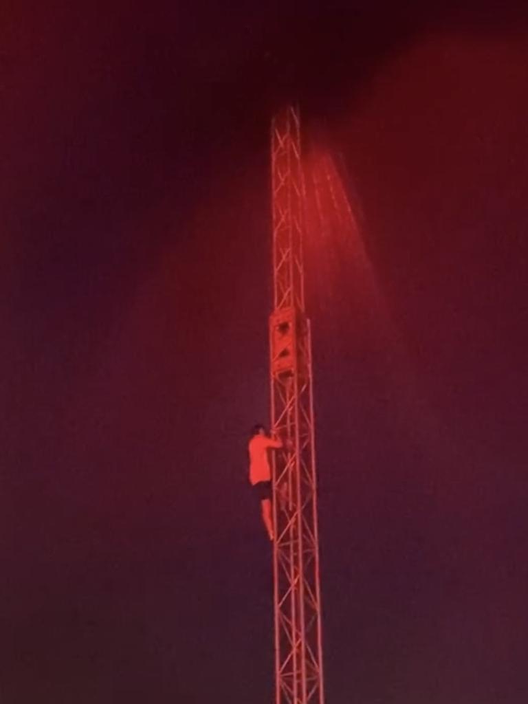 A festival goer is seen climbing the rails of Wildlands festival. Picture: Supplied