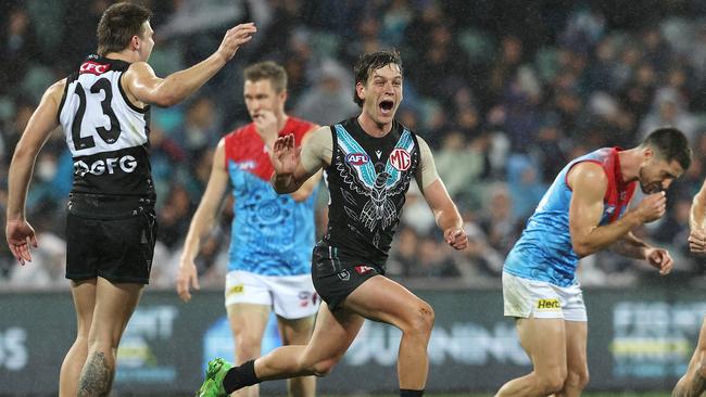 Zak Butters celebrates one of his two goals against the Demons. Picture: Sarah Reed/AFL Photos via Getty Images)