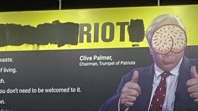 Clive Palmer's campaign board above a Brunswick petrol station has been vandalised with graffiti. Picture: Supplied.
