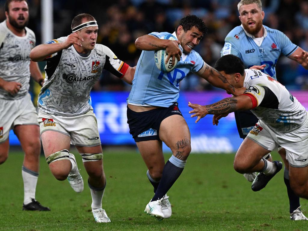 Waratah’ Izaia Perese tries to avoid a tackle from Chiefs’ Kalyum Boshier. Picture: AFP