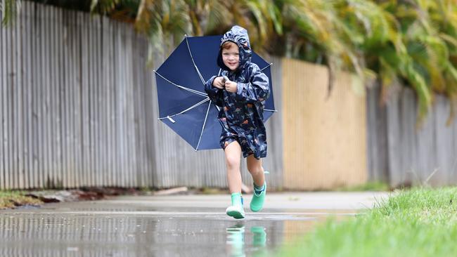 It’s brolly weather in the Far North... again. Cairns youngster Noah Millard, 4, enjoys the return of the wet weather, dressing up in his raincoat and gumboots, and jumping into rain puddles outside his Smithfield home. Picture: Brendan Radke