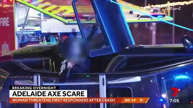 Woman wielding an axe crashes car (7News)