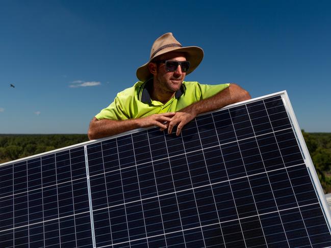 GEM Energy are installing a 99.6kw system on the roof of Crocodylus Park - one of the biggest systems in Darwin. Craig Watson stands on the roof installing one of the many solar panels for the array.Picture: Che Chorley