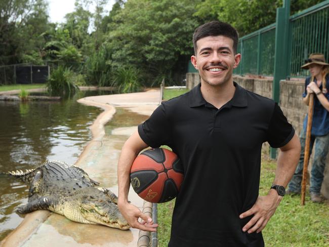 Freddy Webb shows off his basketball skills with monster croc, Speckles, at Crocodylus Park. Picture: Sam Lowe