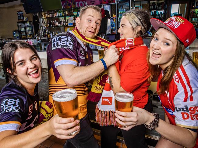 Battle of Caxton Street.The Caxton Hotel staff gearing up for the Broncos vs Dolphins game this weekend.The Caxton Hotel the home of Rugby League in Queensland. Dolphins Amelia Ford (hat) and Kenny Biggs (scarf) with Broncos Stirling Farquhar and Georgie Hull. Picture: NIGEL HALLETT