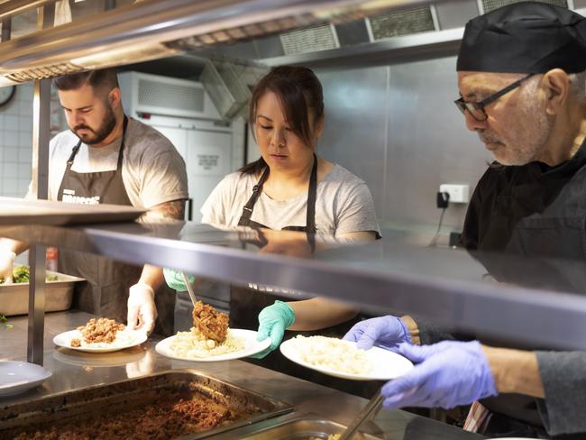 MasterChef contestants Aaron Sanders and Linda Dalrymple serving meals to those in need at St Mary's House Of Welcome Fitzroy. Picture: TEN