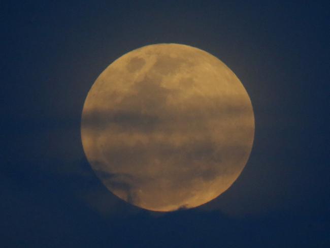 The moon rises over Manila in the Philippines. Picture: AP/Bullit Marquez