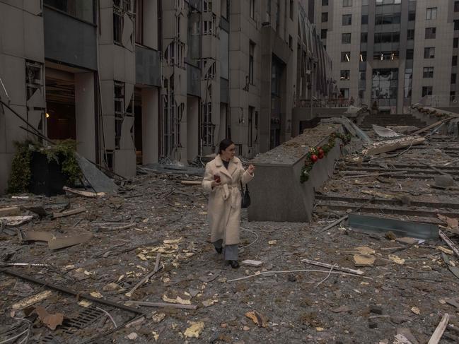 A woman walks among rubble at the site of the missile attack in Kyiv. Picture: AFP