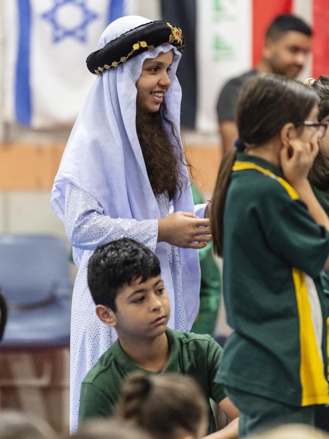 Standing with fellow students representing the Yazidi community is Nazdar Zaghla during Harmony Day celebrations at Darling Heights State School. Picture: Kevin Farmer