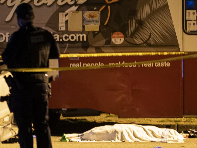 A victim covered with a cloth lies near a food truck after a car drove into a crowd at the Lapu Lapu Festival in Vancouver, British Columbia, Saturday April 26, 2025. (Rich Lam/The Canadian Press via AP)