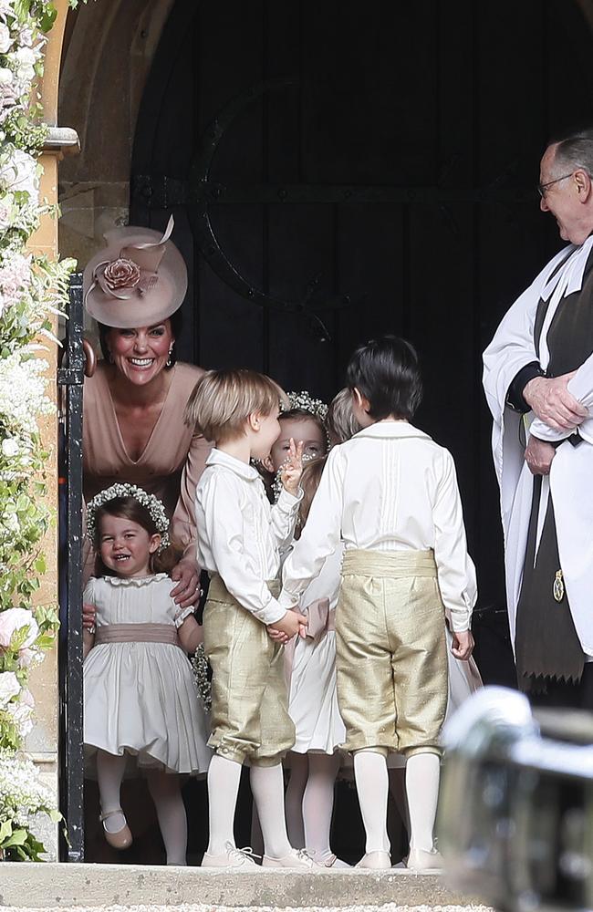 Kate stands with her daughter Princess Charlotte in the church.