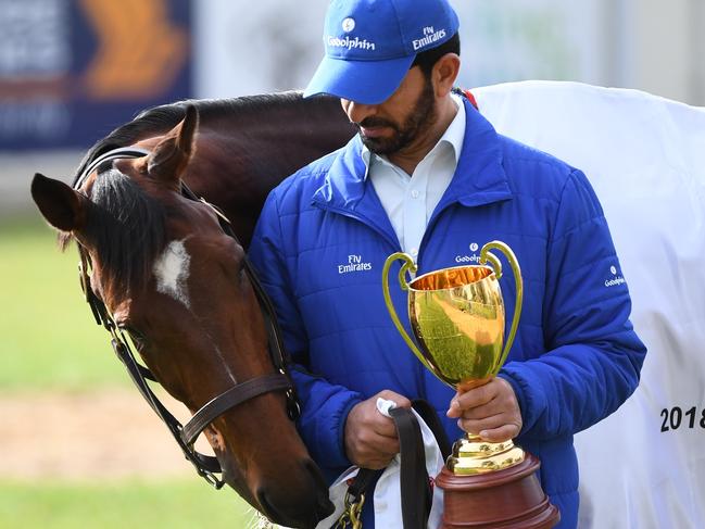 Godolphin trainer Saeed Bin Suroor with Best Solution and the Caulfield Cup trophy.