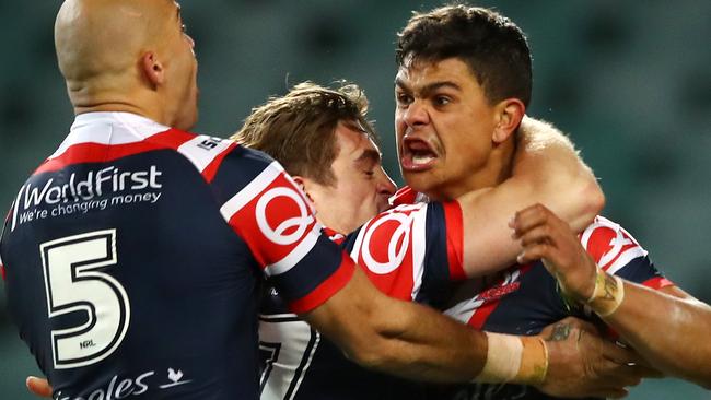 Latrell Mitchell celebrates with Roosters teammates.