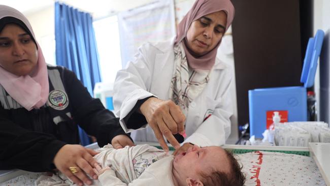 An infant is checked at Al-Zawaida Clinic in the Deir al-Balah in Gaza. Picture: AFP