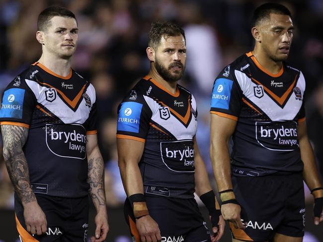 SYDNEY, AUSTRALIA - JULY 12:  John Bateman and Aidan Sezer of the Wests Tigers react after a Sharks try during the round 19 NRL match between Cronulla Sharks and Wests Tigers at PointsBet Stadium on July 12, 2024, in Sydney, Australia. (Photo by Brendon Thorne/Getty Images)