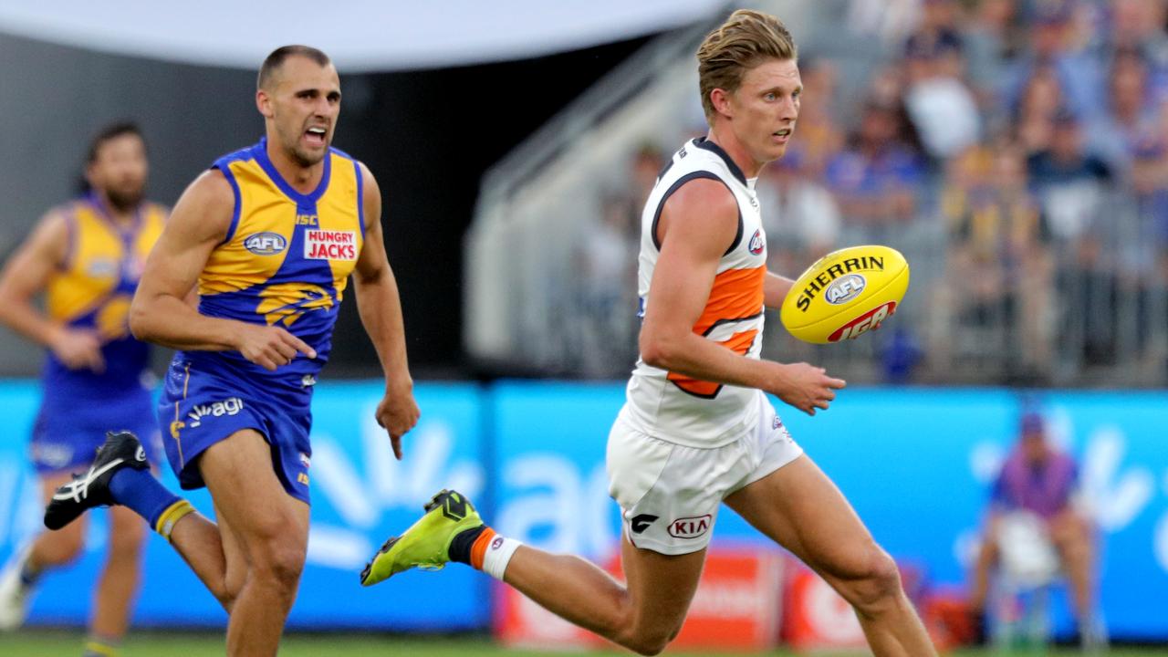 Lachie Whitfield burns away from Dom Sheed against West Coast in Round 2.