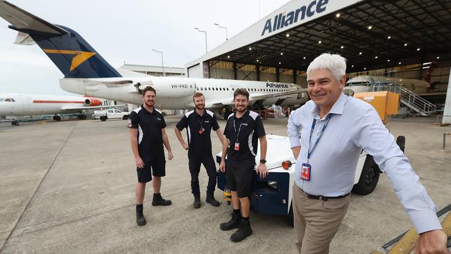 Scott McMillan, Managing Director of Alliance Airlines, with some of his aircraft engineers at their base in Brisbane Airport. Picture: Lyndon Mechielsen