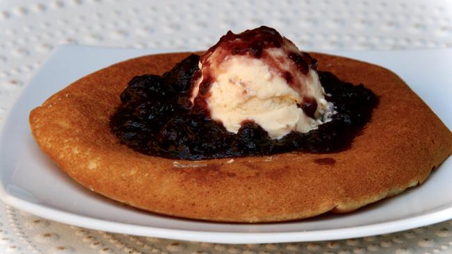 Fluffy gluten free pancakes with homemade berry sauce.