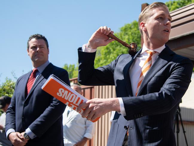 SYDNEY, AUSTRALIA - September 28: Auctioneer Jake Moore bring the hammer down at the end of the auction of 166 Baptist Street, Redfern. The two bedroom property sold for $1.33million to Ben O'Sullivan. (Photo by James Gourley/The Sunday Telegraph)