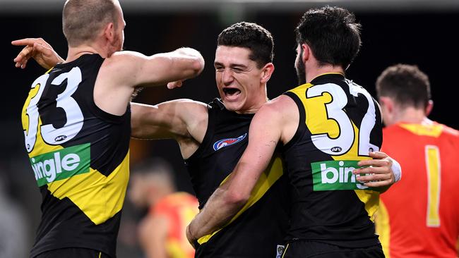 Jason Castagna celebrates a goal with teammates Kamdyn McIntosh and Corey Ellis. Picture: AAP