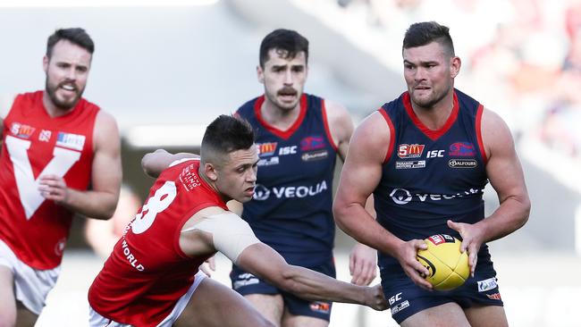 Norwood’s Mitch Grigg evades North’s Robbie Young in the SANFL grand final. Picture: Sarah Reed