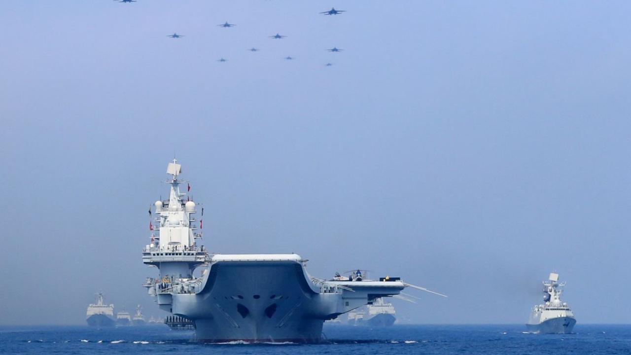 Chinese warships and fighter jets take part in a military display in the South China Sea. Picture: China Stringer Network/Reuters.