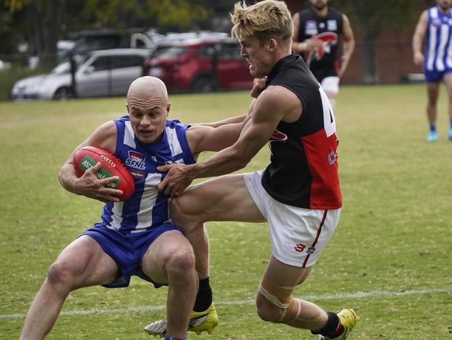 SFL: Kangaroo Stewart Levy tries to fend off Dolphin Nathanael Furlong. Picture: Valeriu Campan