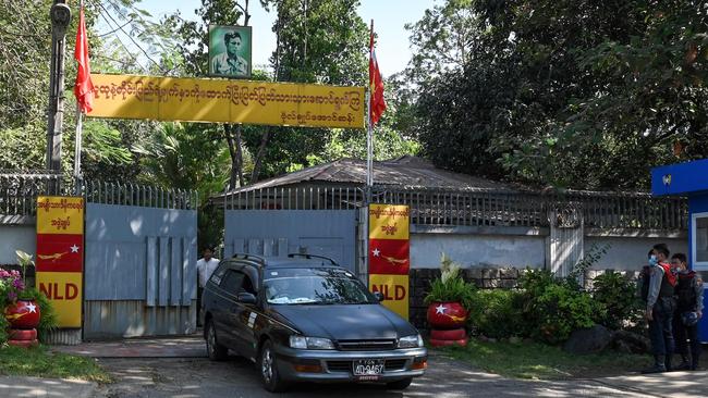 A car leaves the residence of Aung San Suu Kyi in Yangon on Tuesday. Picture: AFP