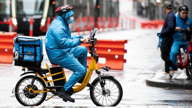 A delivery rider braves heavy rain in Sydney while working. Picture: NCA NewsWire / Bianca De Marchi