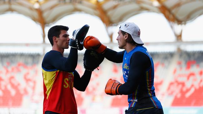 Jaeger O’Meara and David Swallow train at Metricon Stadium.