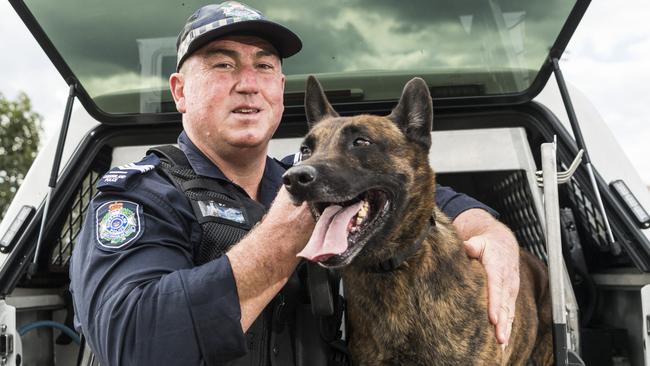 Officer-in-charge Toowoomba Dog Squad Sergeant Trevour O'Neil with Dutch shepherd PD Danko. The represent just one of the roles on offer for today’s police recruits. Picture: Kevin Farmer