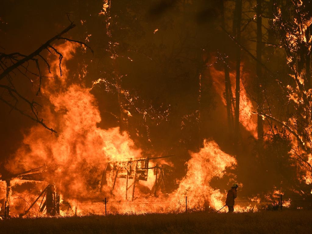 NSW Rural Fire Service crews fight the Gospers Mountain Fire as it impacts a structure at Bilpin, Saturday, December 21, 2019. Conditions are expected to worsen across much of NSW as temperatures tip 40C. Picture: AAP Image / Dan Himbrechts