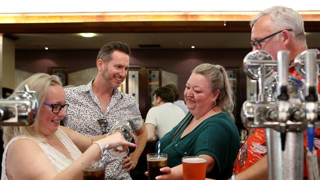 A group of friends stand and enjoy their drinks at a Manchester pub. Picture: Getty Images