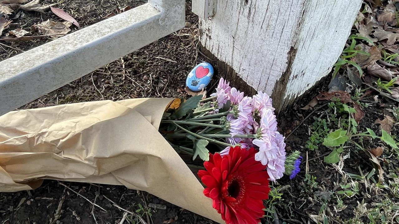 Flowers placed outside the home next to bushland where Ms Kumar’s body was found.